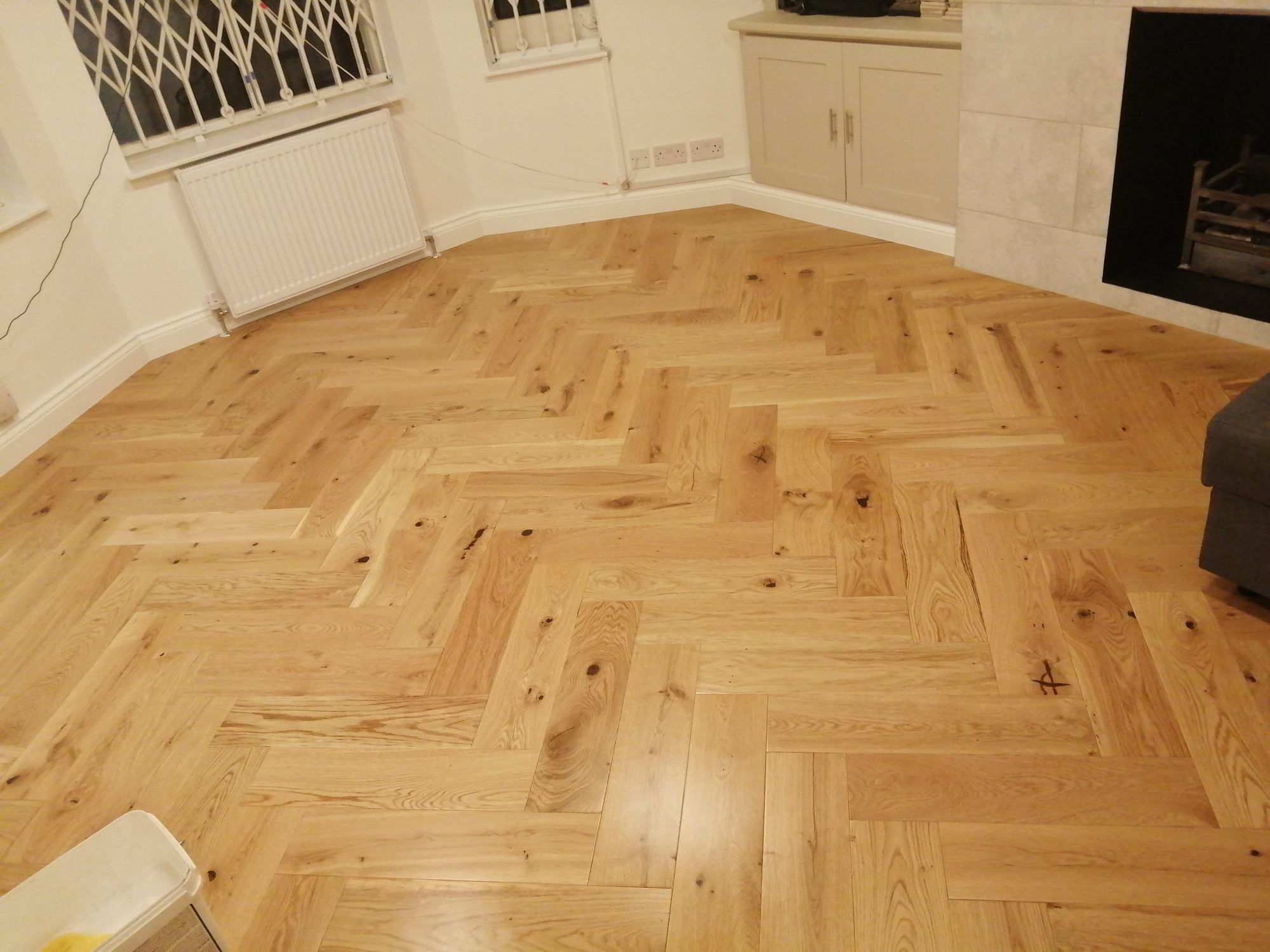 Oak herringbone floor in a bay-window living room
