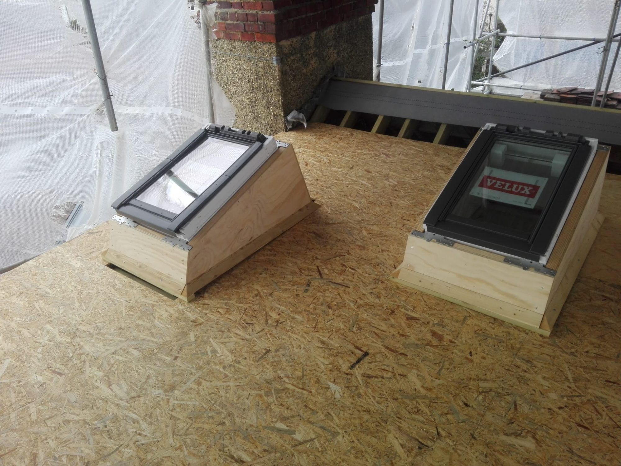 Velux roof windows on kerbs on a new flat roof deck