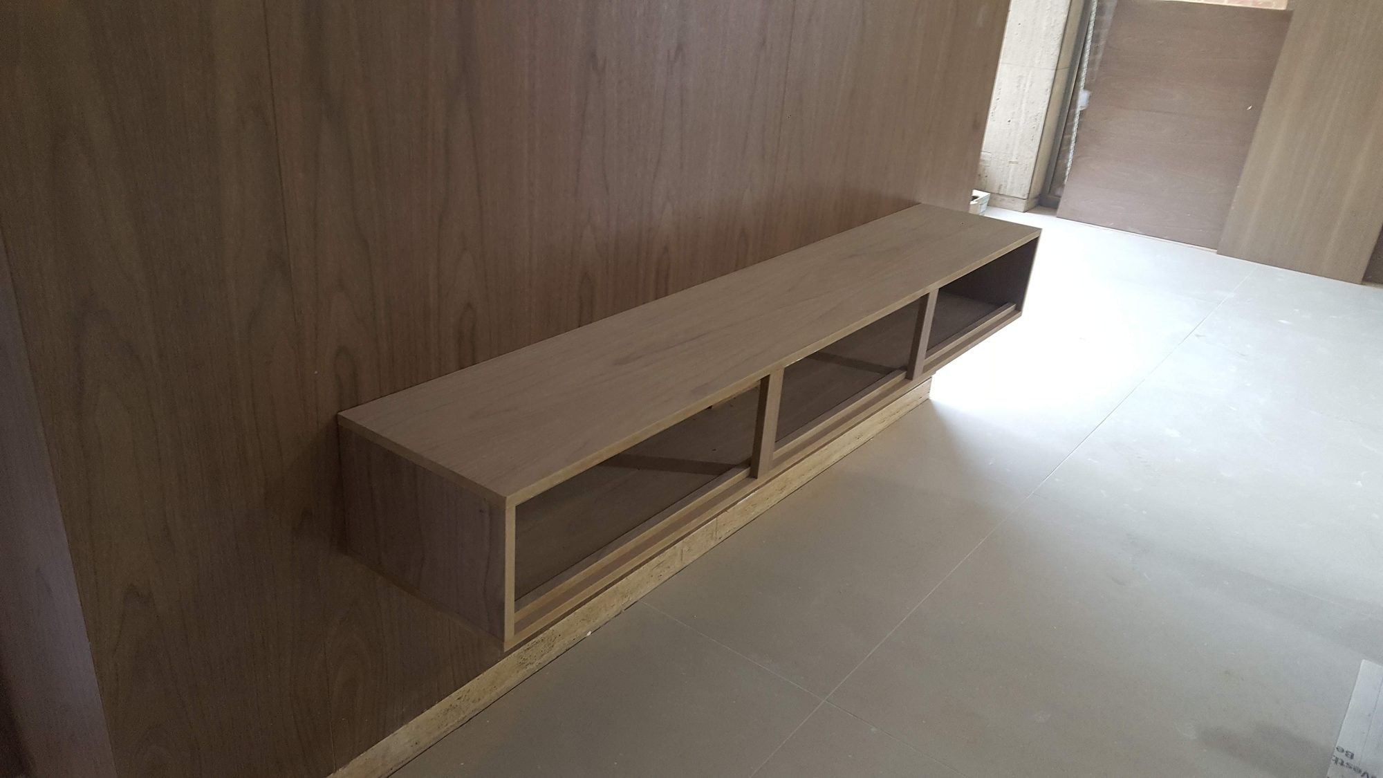 Walnut panelling with a floating bench